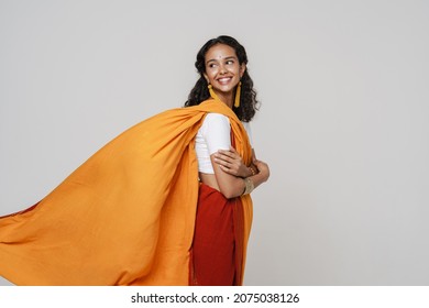 Young south asian woman smiling while posing in sari isolated over white wall