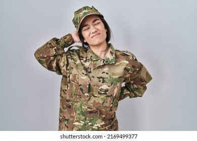 Young South Asian Woman Wearing Camouflage Army Uniform Suffering Of Neck Ache Injury, Touching Neck With Hand, Muscular Pain 