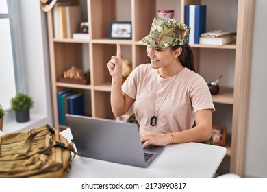 Young South Asian Woman Wearing Camouflage Army Uniform Doing Video Call Smiling With An Idea Or Question Pointing Finger With Happy Face, Number One 