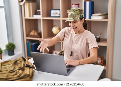 Young South Asian Woman Wearing Camouflage Army Uniform Doing Video Call Celebrating Achievement With Happy Smile And Winner Expression With Raised Hand 