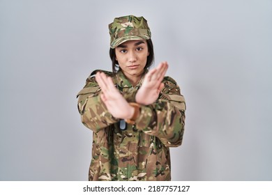 Young South Asian Woman Wearing Camouflage Army Uniform Rejection Expression Crossing Arms And Palms Doing Negative Sign, Angry Face 