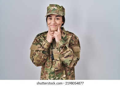 Young South Asian Woman Wearing Camouflage Army Uniform Smiling With Open Mouth, Fingers Pointing And Forcing Cheerful Smile 