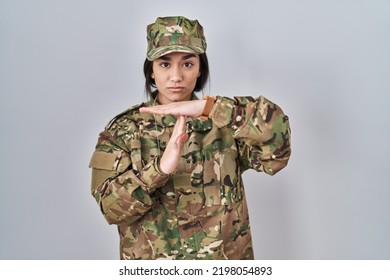 Young South Asian Woman Wearing Camouflage Army Uniform Doing Time Out Gesture With Hands, Frustrated And Serious Face 