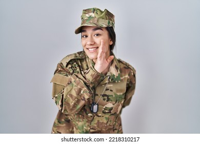 Young South Asian Woman Wearing Camouflage Army Uniform Hand On Mouth Telling Secret Rumor, Whispering Malicious Talk Conversation 