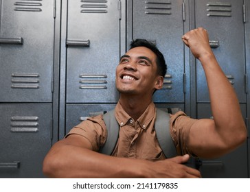 A Young South East Asian Student Celebrates In Front Of Campus Lockers Smiling