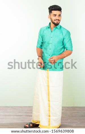young South Indian man in traditional dress, dhoti and shirt