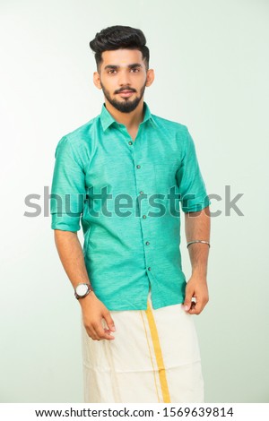 young South Indian man in traditional dress, dhoti and shirt