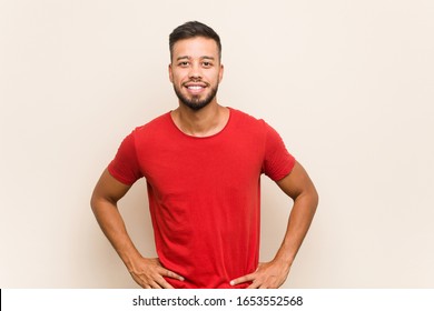 Young South-asian Man Confident Keeping Hands On Hips.