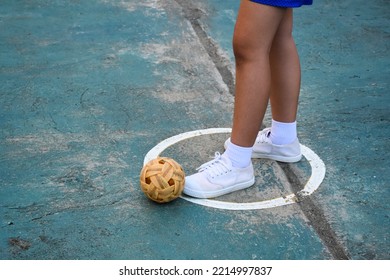 Young southeast asian female sepak takraw player standing near the ball in the serving center area of the court, outdoor sepak takraw playing after school, soft and selective focus, - Shutterstock ID 2214997837