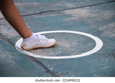 Young southeast asian female sepak takraw player step her left foot in the serving center area of the court, outdoor sepak takraw playing after school, soft and selective focus, - Shutterstock ID 2214998121