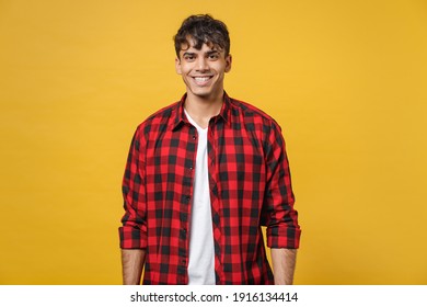 Young Spanish Latinos Attractive Handsome Smiling Cheerful Stylish Fashionable Student Man 20s Wear Red Checkered Shirt, White T-shirt Look Camera Isolated On Yellow Color Background Studio Portrait