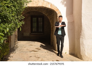 Young Spanish Man With Jacket, Pants And Black Dancing Shoes, White Shirt And Green Vest, Dancing Flamenco In The Street. Typical Spanish Concept, Art, Dance, Culture, Tradition.