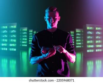 Young IT specialist. Man manager IT company. Control of server hardware via tablet. IT specialist with tablet computer. Blurred server equipment behind man. Server maintenance service concept - Shutterstock ID 2205968071