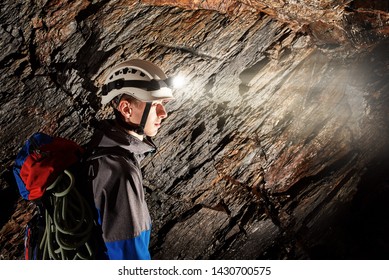 Young speleologist exploring a cave