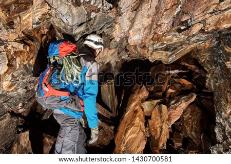 Young speleologist exploring a cave