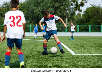 Young Sport Boys In White Sportswear Running And Kicking A  Ball On Pitch. Soccer Youth Team Plays Football In Summer. Activities For Kids, Training	