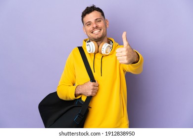 Young Sport Caucasian Man With Bag Isolated Purple Background With Thumbs Up Because Something Good Has Happened