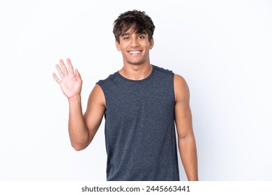 Young sport caucasian man isolated on white background saluting with hand with happy expression - Powered by Shutterstock