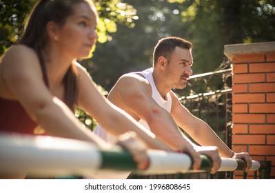 Young sport couple working exercise in the park. Focus is on background.  - Shutterstock ID 1996808645