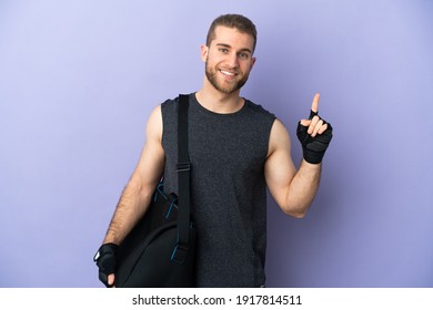 Young Sport Man With Sport Bag Isolated On White Background Showing And Lifting A Finger In Sign Of The Best