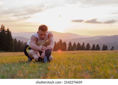 Young sport man doing stretching exercise outdoor before run. - Powered by Shutterstock