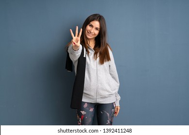 Young Sport Woman Happy And Counting Three With Fingers