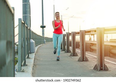 young sport woman is jogging and doing sport outdoors at sunset