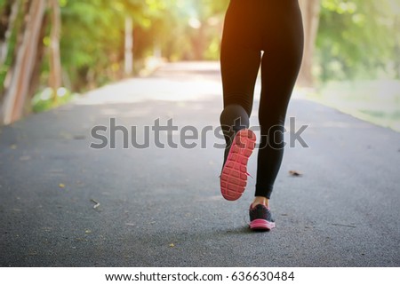 young sport woman running On the road in the Park.