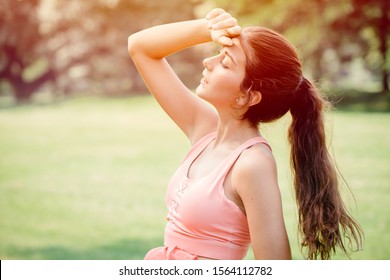 Young sport woman tired headache discomfort expression overheat from hot weather summer season. - Powered by Shutterstock