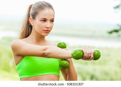 Young Sporting Woman With Dumbells