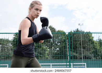 young sportive blond female boxer training , ready to punch - Powered by Shutterstock