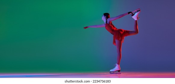 Young sportive girl, junior female figure skater in red stage costume skating isolated over gradient green-blue background in neon. Athlete in motion. Sport, beauty, winter sports. Copy space for ad - Shutterstock ID 2234736183