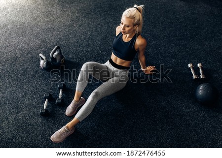 Image, Stock Photo young woman foam rolling after exercise in gym