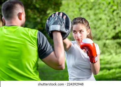 Young Sports Couple Training To Box In The Park