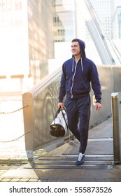 Young Sports Man With Bag Walking Along Urban Bridge