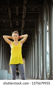 Young Sports Woman In Fitness Clothes On Pont De Bir-Hakeim Bridge In Paris Relaxing After Workout.