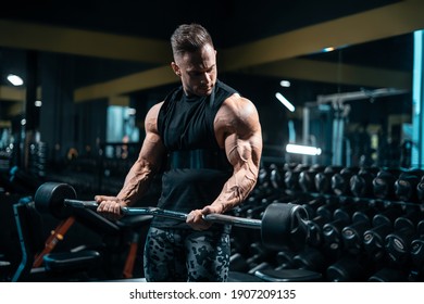 young sportsman bodybuilder have workout and exercising with barbell in gym - Powered by Shutterstock