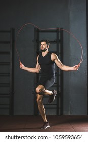 Young Sportsman Doing Jump Rope Workout In Gym