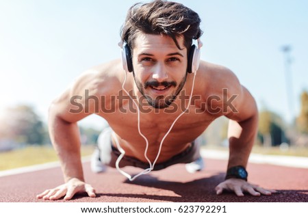 Similar – Image, Stock Photo Young athletic caucasian listening to music at sunset