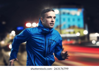 Young sportsman jogging in the night city - Powered by Shutterstock