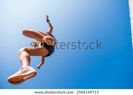 Similar – Unrecognizable women jumping over garden fence background