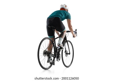 Young sportswoman on road bike bicycle, female cycling athlete practicing isolated on white studio background. Concept of sport, action, motion, speed, race. Copy space for ad. Back view