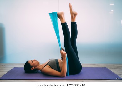 Fitness girl stretching legs doing pilates leg stretches exercises in gym.  athlete exercising abductor hip flexor muscle Stock Photo - Alamy