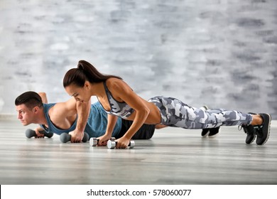 Young Sporty Couple Training In Gym