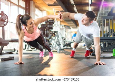 Young Sporty Couple Working Out Together At Gym.