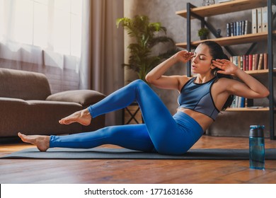 Young Sporty Fit Woman On Floor Doing Bicycle Crunch Fitness Exercise At Home