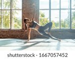 Young sporty fit woman trainer do practice individual hatha yoga instructor training Vasisthasana side plank,arm leg support balancing pose modern gym mat wooden floor window healthy lifestyle concept