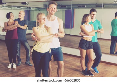 Young Sporty Girls And Men Dancing Salsa Steps