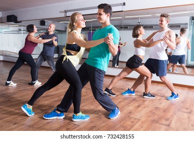 Young Sporty Girls And Men Dancing Salsa Steps