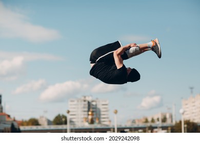 Young sporty guy doing parkour at the city street - Powered by Shutterstock